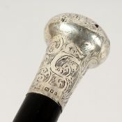 AN EDWARDIAN WALKING CANE with engraved silver handle. London 1904. 3ft long.
