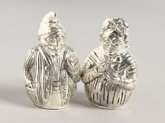 A PAIR OF .800 SILVER PUNCH AND JUDY SALT AND PEPPERS. 2ins high.