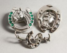 THREE SILVER HORSESHOE BROOCHES.