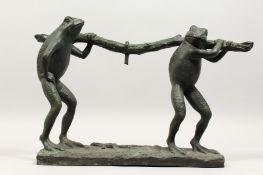 AN AMUSING CAST BRONZE GROUP OF TWO FROGS CARRYING A TREE BRANCH. 22ins long.