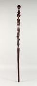 A NATIVE CARVED SNAKE WALKING STICK. 3ft 1ins long.