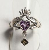 A SILVER HEART SHAPED RING.
