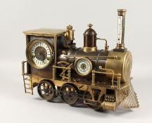 A GOOD AMERICAN LOCOMOTIVE CLOCK with thermometer, barometer and clock dial. 17ins long x 15ins