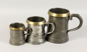 THREE EARLY PEWTER AND BRASS MEASURES. 6ins, 4.5ins and 3ins.