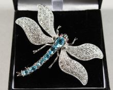 A SILVER AND BLUE TOPAZ DRAGONFLY BROOCH.