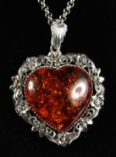 A SILVER AMBER HEART PENDANT AND CHAIN.