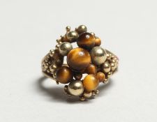 A 9CT GOLD TIGER'S EYE RING.
