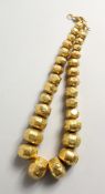 AN IRANIAN GILT NECKLACE.
