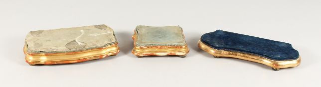 THREE SMALL GILDED STANDS. 10ins, 8.5ins and 5ins wide.