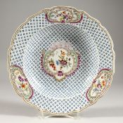A 19TH CENTURY PORCELAIN BLUE FLOWERHEAD PLATE with floral vignettes. Possibly French. 10ins