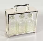 A CHRISTOPHER DRESSER DESIGN SILVER PLATE TANTALUS with three cut glass whisky decanters and
