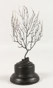 A BLACK CORAL ON A STAND. 6ins.