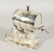 A GOOD SILVER PLATE BEAR HOLDING A WHISKY KEG on a sledge.