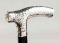A VICTORIAN ENGRAVED SILVER HANDLED WALKING STICK. London 1889. Maker: C. W. 3ft long.