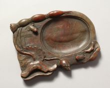 A GOOD CHINESE CARVED SOAPSTONE INKSTONE carved with frogs.