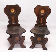 A VERY GOOD PAIR OF REGENCY MAHOGANY HALL CHAIRS, the shaped backs with painted crest on solid