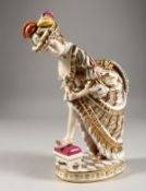 A GOOD RUSSIAN PORCELAIN EROTIC FIGURE OF A LADY, her foot on a stool, a flap on her rear which
