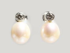 A PAIR OF 18CT WHITE GOLD, PEARL AND DIAMOND EARRINGS. Pearls: 9mm. Diamonds: 0.2cts.