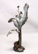 A GOOD LARGE BRONZE SCULPTURE OF BIRDS PERCHED ON A TREE, with broad leaves, on a naturalistic base.