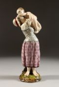 A GOOD HOCHST POTTERY FIGURE OF A MOTHER AND CHILD. Hochst Mark No. 157. 9ins high.