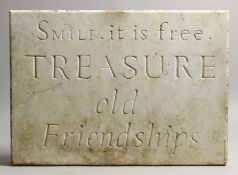 AN ITALIAN CARVED WHITE MARBLE PLAQUE, carved 'Smile It Is Free, TREASURE Old Friendships'. 13ins
