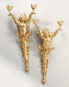 A VERY GOOD PAIR OF GILT BRONZE CHERUB WALL LIGHTS, each with two arms. 29ins long.