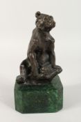 A BRONZE SEATED BEAR on a marble base. 5ins long.
