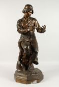 C. MANICLIER A LARGE BRONZE OF A YOUNG MAN, seated on a tree stump. Signed and dated 1881, on an