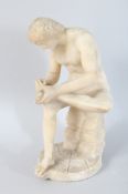 AN ITALIAN CARVED ALABASTER FIGURE, picking a thorn from his foot. 10ins high.