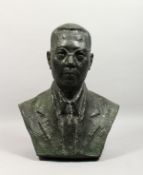 A LARGE BRONZE BUST OF A MAN, wearing spectacles. 21ins high.
