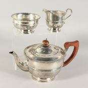A THREE PIECE CIRCULAR TEA SET with beaded edge. Birmingham 1933 & 1934. Weight: 24ozs.