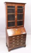 AN 18TH CENTURY WALNUT BUREAU BOOKCASE, the top with a pair of glass doors on a bureau base with