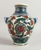 A GOOD IZNIK STYLE TWO HANDLED VASE with floral decoration. 10ins high.