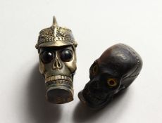 TWO BRASS SKULL VESTAS.