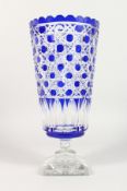 A CUT BLUE CRYSTAL BOHEMIAN TAPERING VASE on square stand. 13ins high.