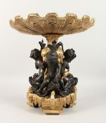 A GOOD GILT BRONZE AND ORMOLU SHELL TAZZA, supported by three bronze cupid. 13ins high.