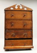AN APPRENTICES OAK FOUR DRAWER TALLBOY, with arched pediment top, turned wood handles, on bun