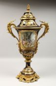 A SUPERB LARGE SEVRES TWO-HANDLED URN VASE AND COVER, the rich blue ground edged in gilt, painted