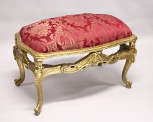 A LARGE GILTWOOD STOOL with red padded top. 3ft 3ins long.