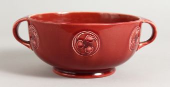 A WILLIAM MOORCROFT CIRCULAR RED TWO HANDLED CHRISTOPHER DRESSER DESIGN BOWL. 6ins diameter.