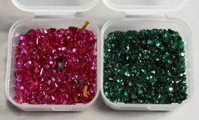 TWO SMALL BOXES OF RUBIES AND EMERALDS.