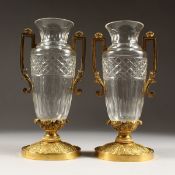 A GOOD PAIR OF EMPIRE CUT GLASS AND ORMOLU VASES with ormolu handles, on circular bases. 10.5ins