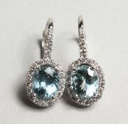 A PAIR OF 18CT WHITE GOLD, AQUAMARINE AND DIAMOND EARRINGS. Aquamarine: 3.10cts. Diamonds: 0.45cts.