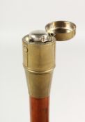 A 19TH CENTURY WALKING CANE with brass top opening to reveal an inkwell. 3ft long.