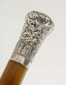 A SUPERB 19TH CENTURY RHINO TWO-PIECE WALKING CANE, with repousse silver handle, in the Indian