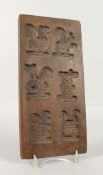 A TREEN BISCUIT MOULD. 12ins x 5.5ins.