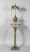 A SILVER PLATED CORINTHIAN COLUMN OIL LAMP with cut glass reservoir. 30ins high.