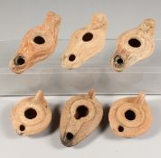 SIX ROMAN POTTERY OIL LAMPS.