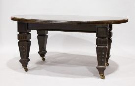 A LARGE MAHOGANY WIND-OUT DINING TABLE, with bow end leaves, on carved tapering legs with castors.