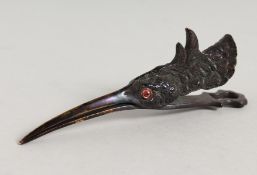 A BRASS SNIPE LETTER CLIP.